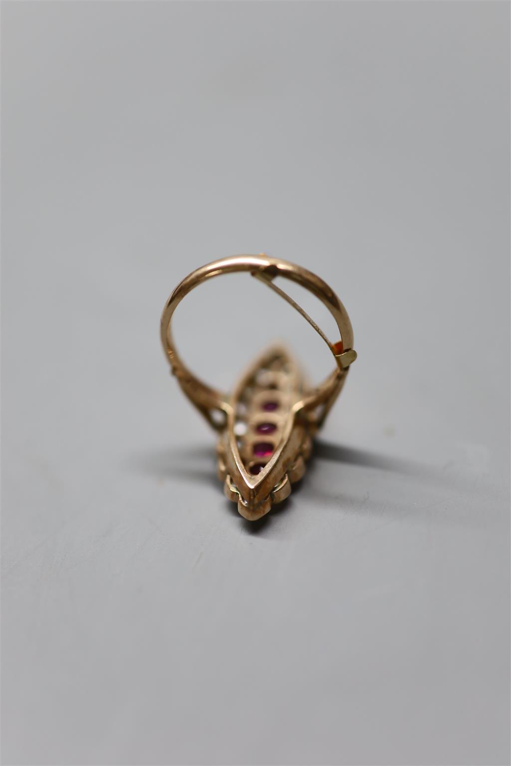 A yellow metal, ruby and split pearl cluster set marquise shaped dress ring, size Q, gross 5.8 grams.